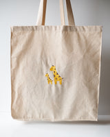 Alternative shot of the front of the giraffe embroidery tote bag