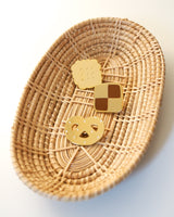 Set of all 3 different Shiny gold-colored hard enamel pins displayed in a basket